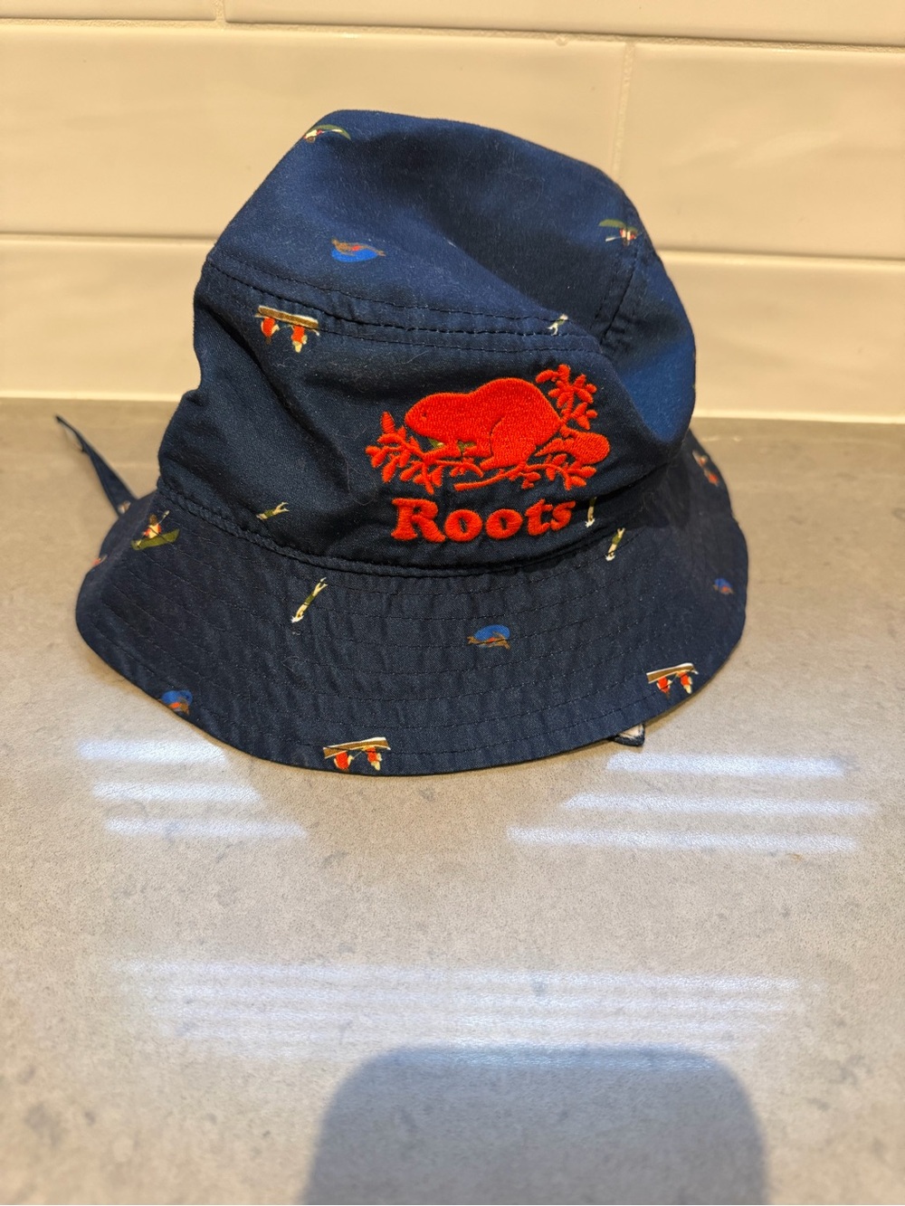 Roots 12-24m navy Bucket Hat with Red Logo